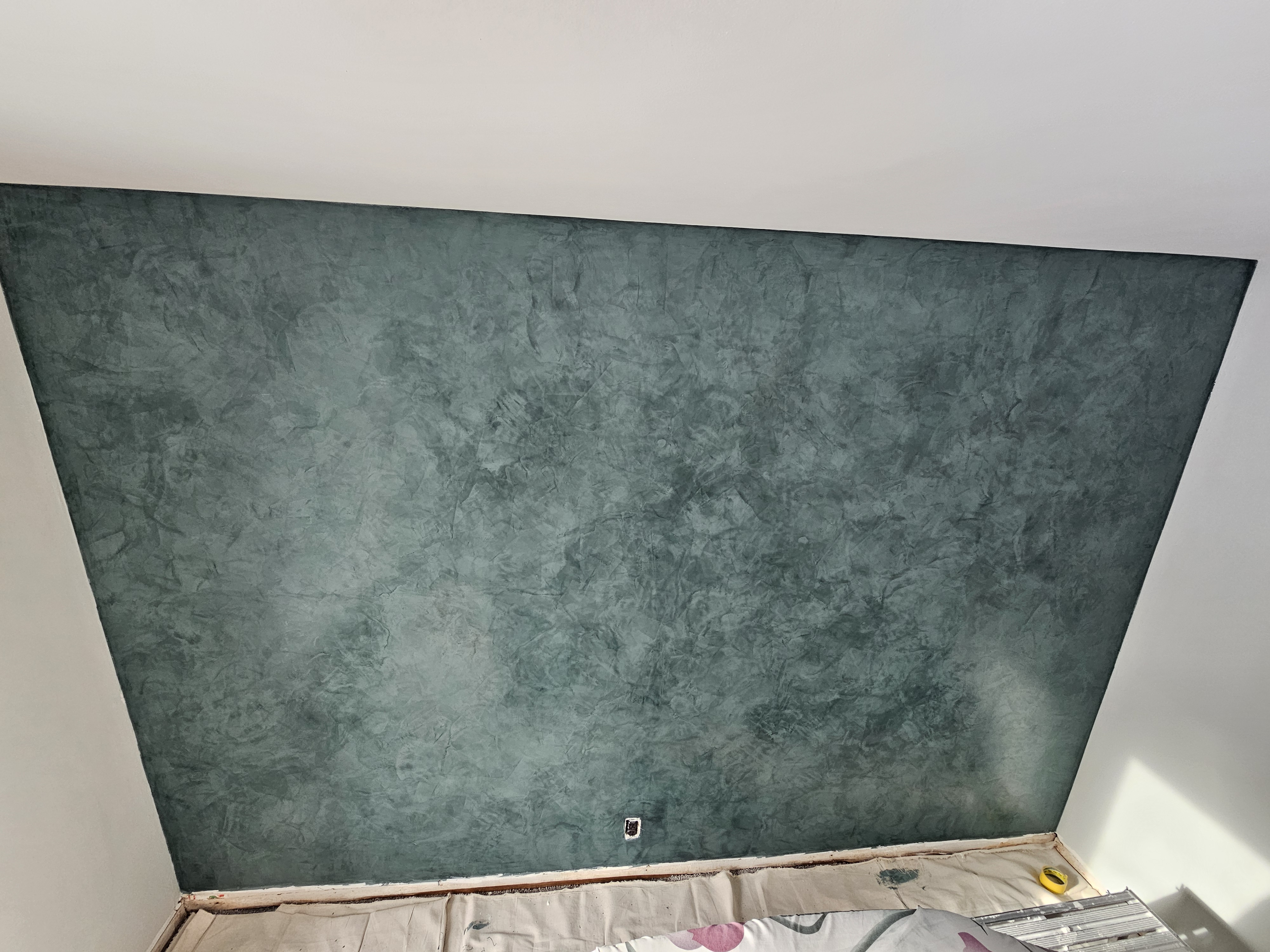 Polished plaster feature wall in a deep teal finish