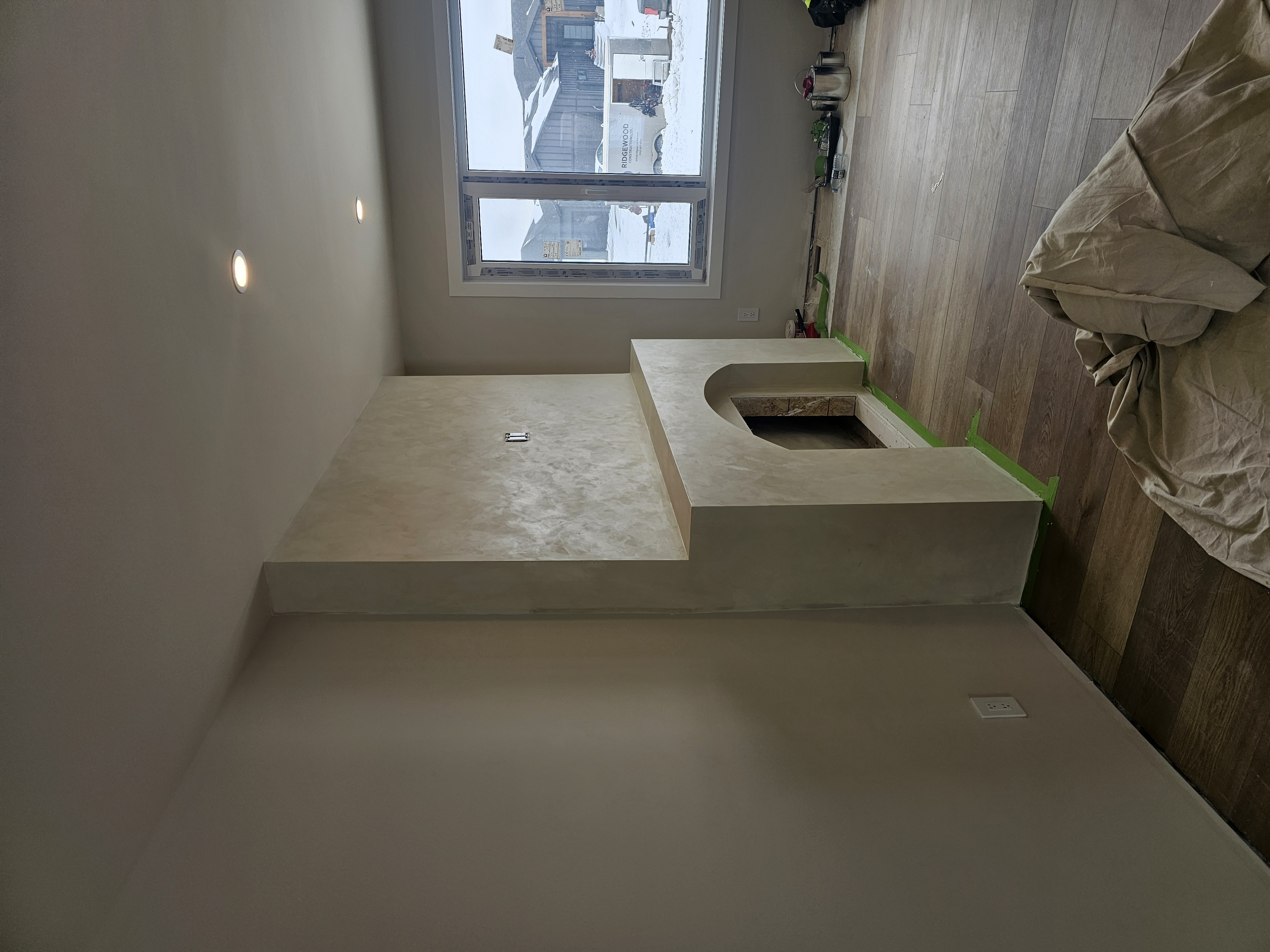Plastered fireplace and window wall